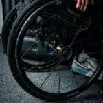 a person in a wheel chair with their hand on the wheel