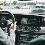 person in gray long sleeve shirt driving car